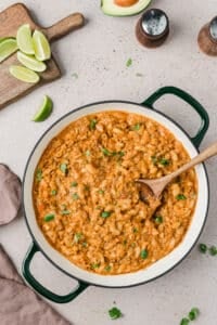 A skillet filled with taco mac and cheese and garnished with cilantro.