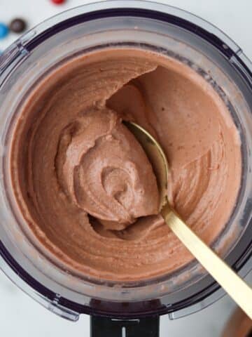 Spooning soft chocolate ice cream from a Ninja Creami container.