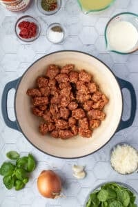 Crumbled Italian sausage in a Dutch oven.
