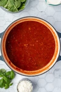 A pot of tomato based soup ready to simmer.