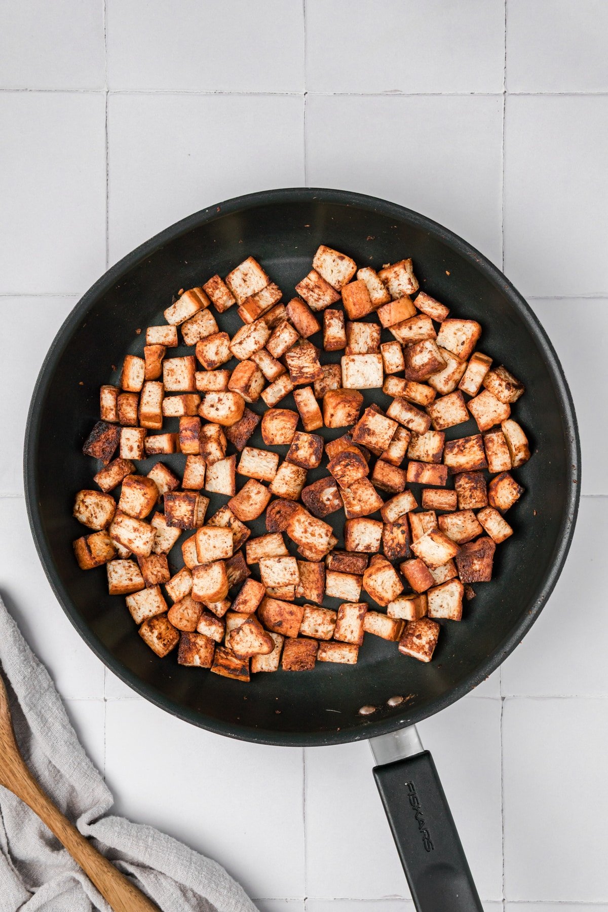 A skillet with browned homemade croutons.