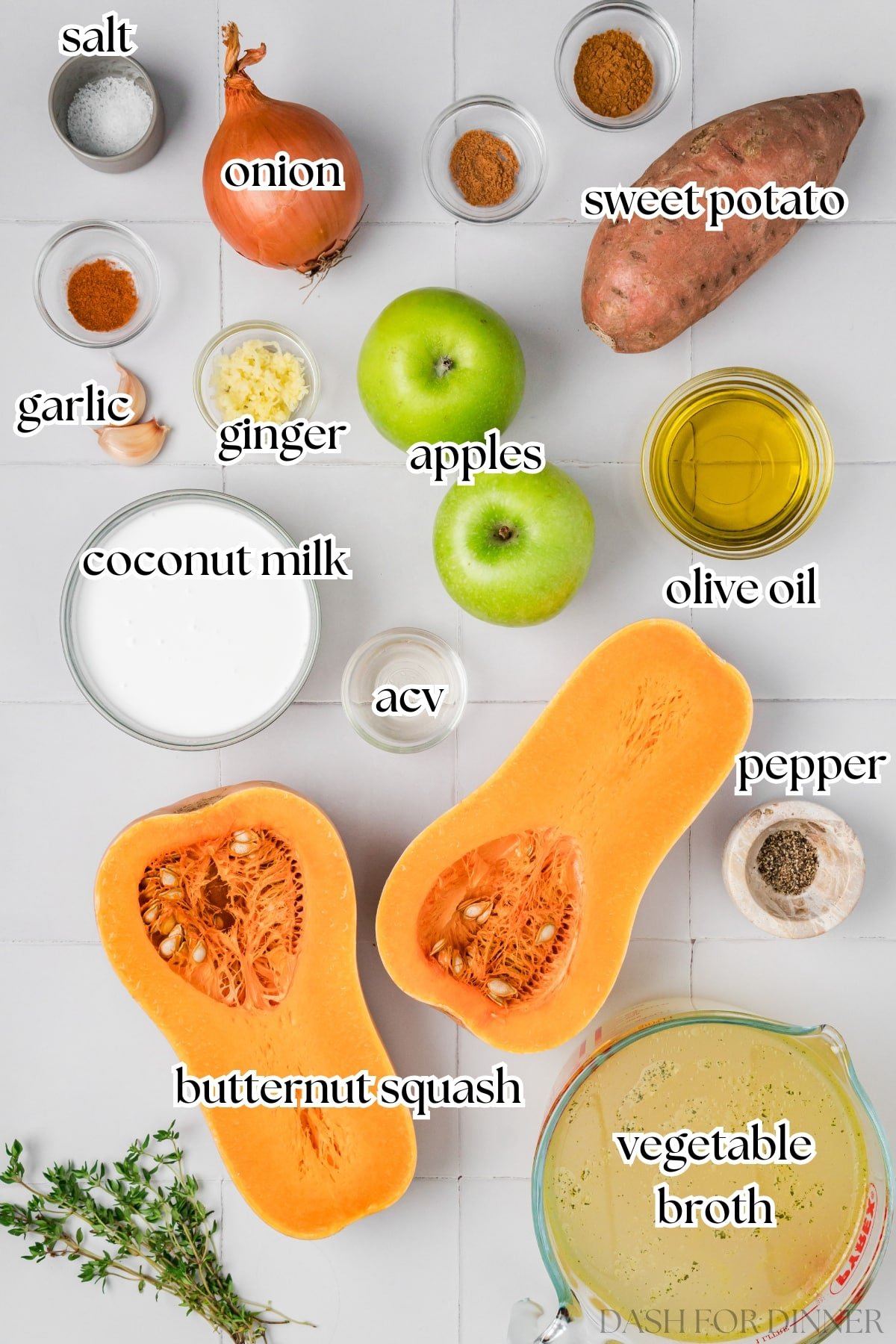 The ingredients needed to make butternut squash and apple soup, including broth, onios, and coconut milk.