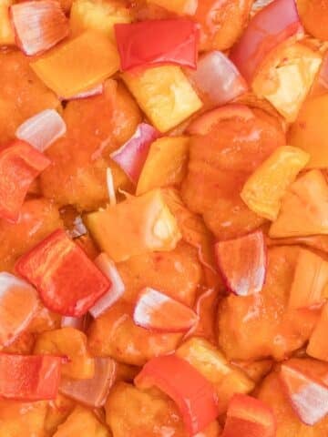 Chicken, peppers, and onions coated in a sweet and sour sauce.