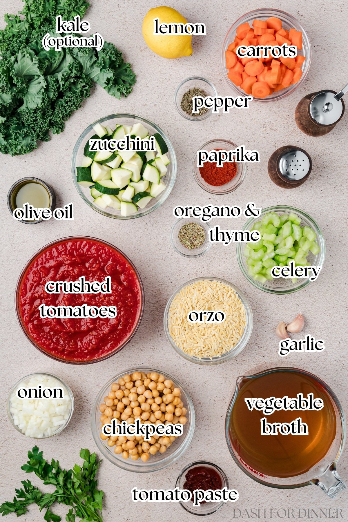 The ingredients needed to make vegetable soup, including zucchini, kale, crushed tomatoes, and onion.