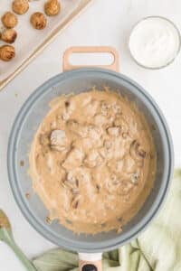 A creamy sauce with mushrooms in a large skillet.