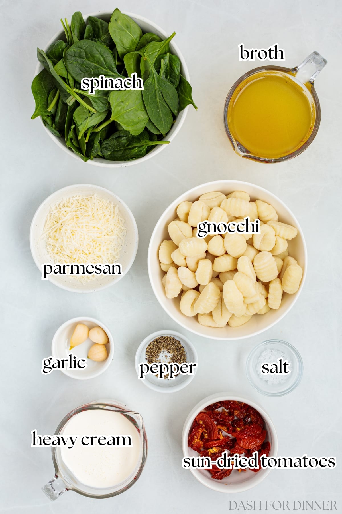 The ingredients needed to make slow cooker chicken meatballs and gnocchi, including spinach, parmesan, and sun-dried tomatoes.