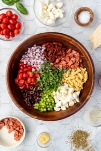 A salad bowl with compartments of toppings and ingredients arranged in a wheel.