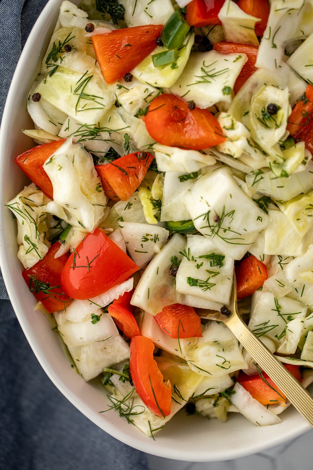 A cabbage salad with red pepper and a vinegar brine.
