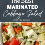A bowl of cabbage salad with red pepper, dill, and pepper.