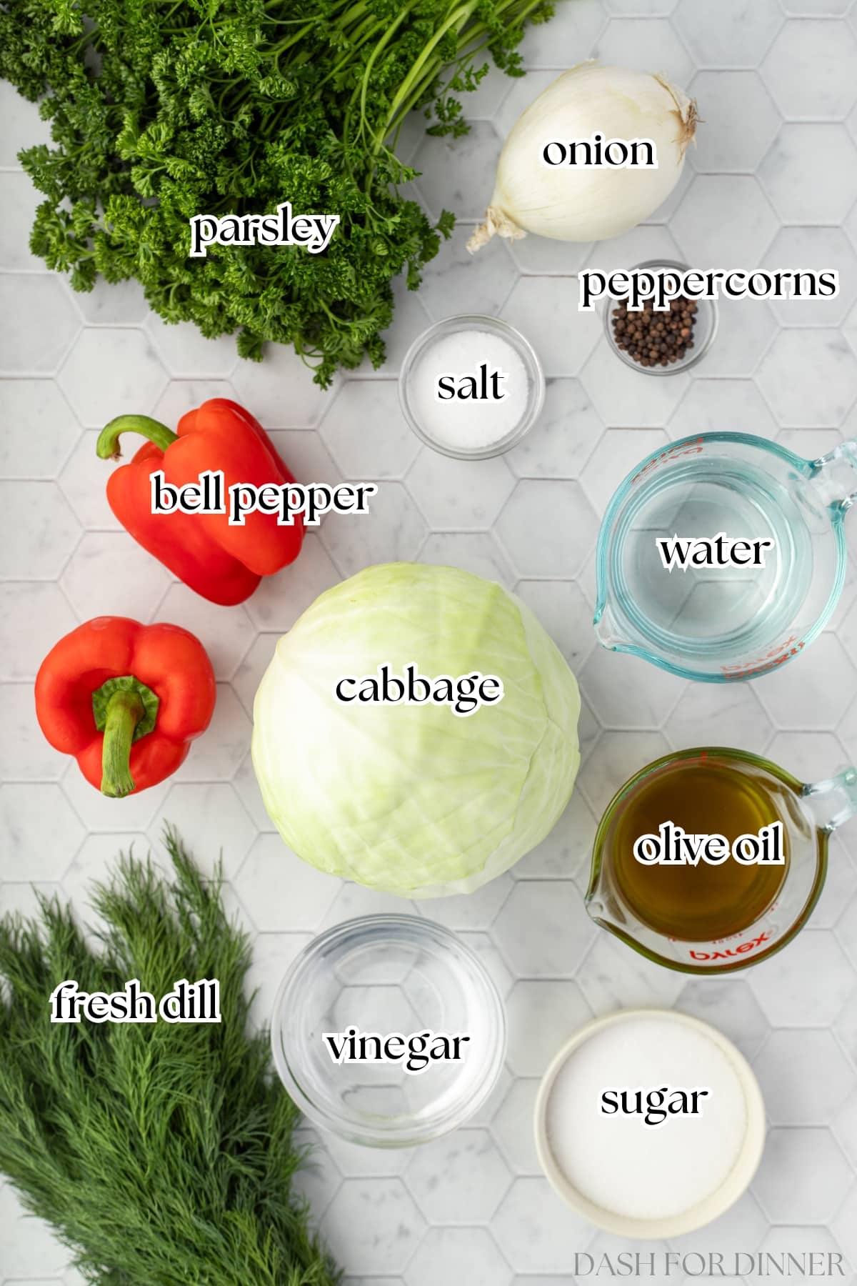 The ingredients needed to make cabbage salad, including red pepper, vinegar, sugar, and fresh herbs.