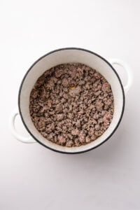 Browning Italian sausage in a Dutch oven.